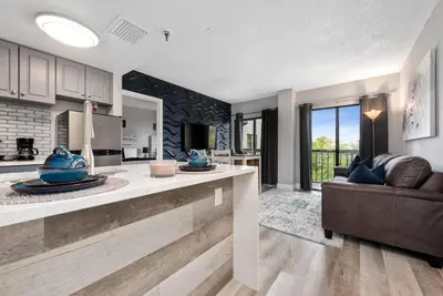 a kitchen and living room with a couch at Apartment with Volcano Bay view in Orlando