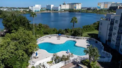 an overhead view of a swimming pool with a large lake at Apartment with Volcano Bay view in Orlando