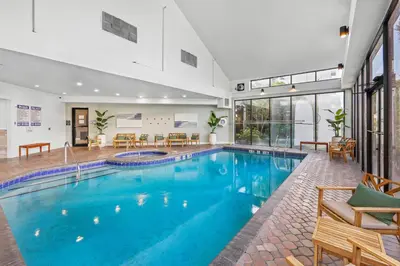a swimming pool with blue water in a house at Apartment with Volcano Bay view in Orlando