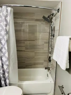 a bathroom with a tub and a toilet and a sink at 2bdrm Home near Orl Fairgrd, Downtwn, Wekiva Sprng in Orlando