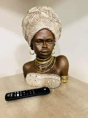 a statue of a woman sitting next to a remote control at 2bdrm Home near Orl Fairgrd, Downtwn, Wekiva Sprng in Orlando