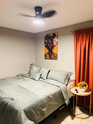 a bedroom with a bed and a painting on the wall at 2bdrm Home near Orl Fairgrd, Downtwn, Wekiva Sprng in Orlando