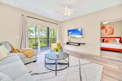 a living room with a couch and a table at Modern 2BR Condo - Pool - Near Disney in Orlando