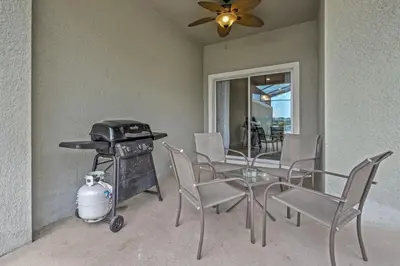 a dining room with a table and a grill at Cozy Home Near Disney Parks - Prime Location in Kissimmee