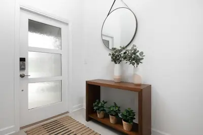 a mirror on top of a table next to a door at Modern Chic-Spacious, Private Pool, Prime Location in Kissimmee
