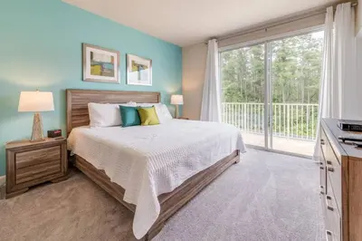 a bedroom with a bed and a large window at Cozy Villa Private Pool Prime Spot in Orlando
