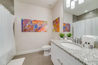 a white bathroom with a sink and a toilet at Cozy Villa Private Pool Prime Spot in Orlando