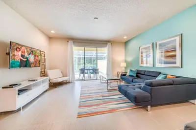 a living room with a couch and a table at Cozy Villa Private Pool Prime Spot in Orlando