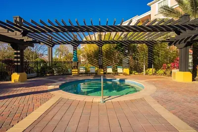 a swimming pool in a courtyard with a pergola at Leisure & Business Oasis-Near Convention Center in Orlando