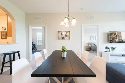 a dining room and living room with a table and chairs at Central Elegance-Spacious Beautifully Decor Condo in Orlando
