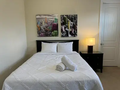 a bedroom with a white bed with two towels on it at 351-AFV · 351 hiden retreat 6bepoolgameroom in Orlando