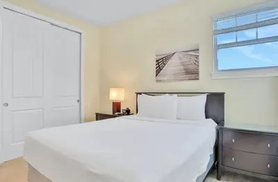 a bedroom with a large white bed and a window at 351-AFV · 351 hiden retreat 6bepoolgameroom in Orlando