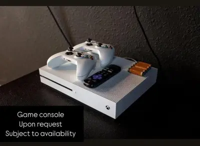 a video game console and a remote control on a table at 351-AFV · 351 hiden retreat 6bepoolgameroom in Orlando
