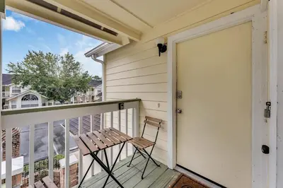 a porch with a chair and a door at Gorgeous Place Minutes Away from Attractions in Kissimmee