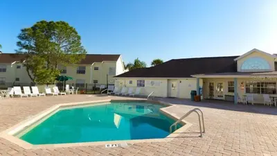 a large swimming pool in front of a building at Gorgeous Place Minutes Away from Attractions in Kissimmee