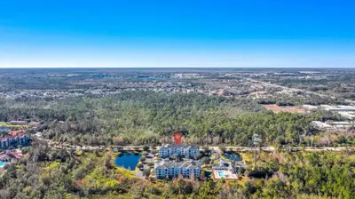 an aerial view of a resort with a lake at The Secret Rose Apartment - Modern & Stylish - 8 Mins from Disney in Kissimmee