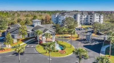 an aerial view of a apartment complex with a parking lot at The Secret Rose Apartment - Modern & Stylish - 8 Mins from Disney in Kissimmee