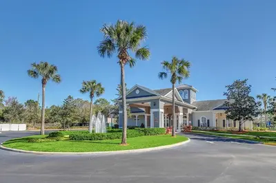 a house with palm trees in the driveway at The Secret Rose Apartment - Modern & Stylish - 8 Mins from Disney in Kissimmee