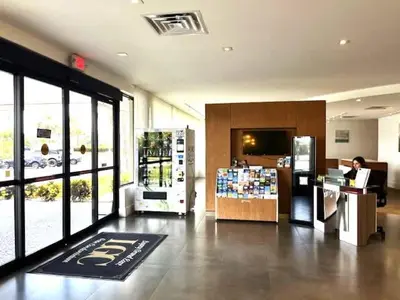 a woman sitting at a counter in a store at Newly renovated room in cozy hotel near Disney 2 in Kissimmee