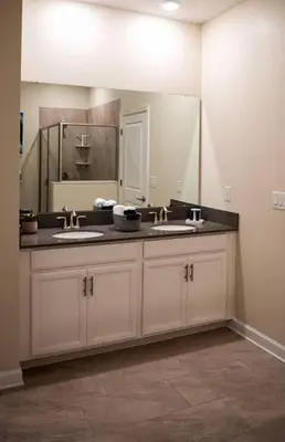 a bathroom with two sinks and a large mirror at Luxury and Fun near DISNEY PARKS 9BR in Kissimmee