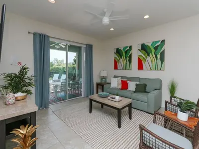 a living room with a couch and a table at Gorgeous Remo 8 BR at Encore Resort next to Disney in Orlando