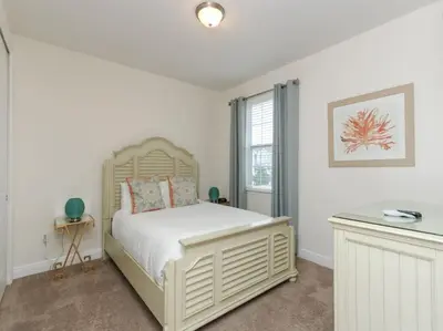 a bedroom with a white bed and a window at Gorgeous Remo 8 BR at Encore Resort next to Disney in Orlando