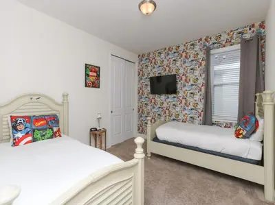 a bedroom with two beds and a tv on the wall at Gorgeous Remo 8 BR at Encore Resort next to Disney in Orlando