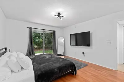 a bedroom with a bed and a flat screen tv at DONOT BOOK thakn you in Kissimmee