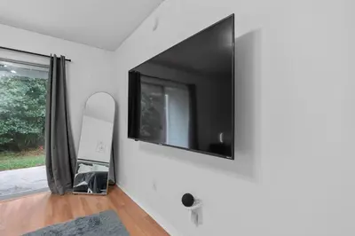 a living room with a tv on the wall at DONOT BOOK thakn you in Kissimmee