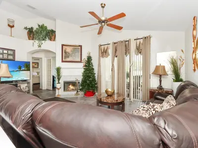 a living room with a leather couch and a fireplace at No place like home in Oviedo