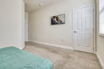 a bedroom with a bed and a picture on the wall at Distinctive Home Private Pool in Orlando