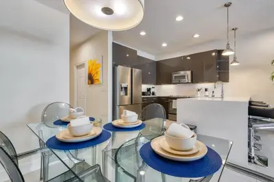 a kitchen and dining room with a glass table and chairs at Distinctive Home Private Pool in Orlando
