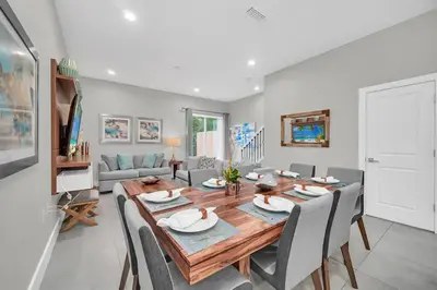 a dining room with a wooden table and chairs at Magical Residence Resort, 5 min Disney in Orlando