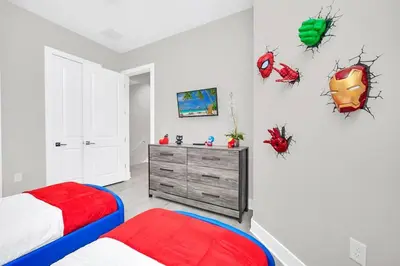 a bedroom with two beds and a dresser at Magical Residence Resort, 5 min Disney in Orlando