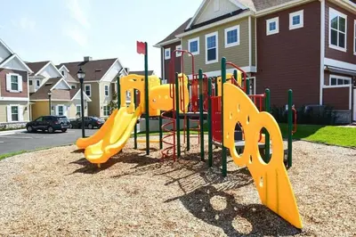 a playground with a yellow slide in a park at Magical Residence Resort, 5 min Disney in Orlando