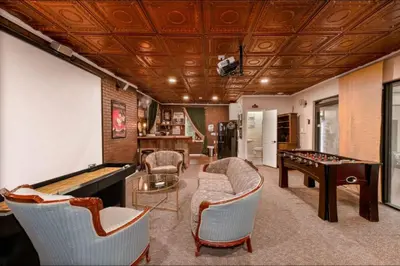 a living room with a pool table and ping pong at 4,800 sf Estate Pool Lake Weddings and Events in Orlando