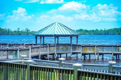 a wooden pier with a gazebo on the water at ORLANDO - BLUE HERON Great Apt - 7 pax in Orlando