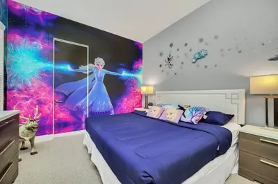 a bedroom with a purple bed with a painting on the wall at NEW awesome dream house, 5 Min to Disney in Orlando