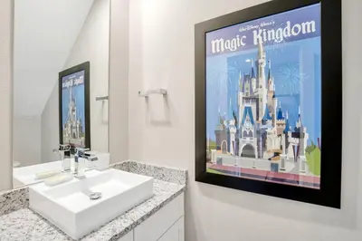 a bathroom with a sink and a poster of the magic kingdom at New Awesome decorated dreamhouse in Orlando