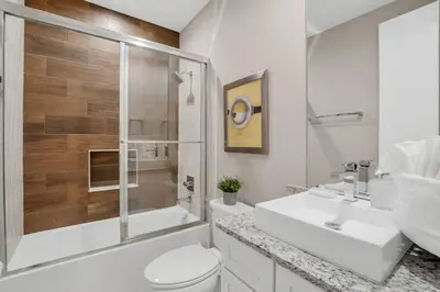 a bathroom with a toilet and a sink and a shower at New Awesome decorated dreamhouse in Orlando