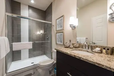 a bathroom with a toilet and a shower and a sink at Super cozy home with private pool in Orlando