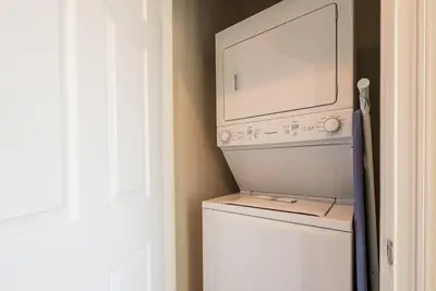 a washer and dryer in a room with a window at Super cozy home with private pool in Orlando