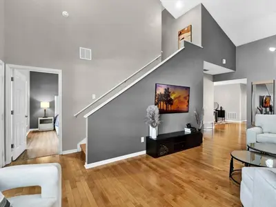 a living room with a staircase and a couch at Beautiful townhouse centrally located in Orlando