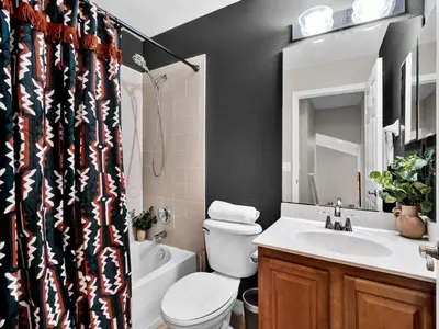 a bathroom with a toilet and a sink and a shower at Beautiful townhouse centrally located in Orlando