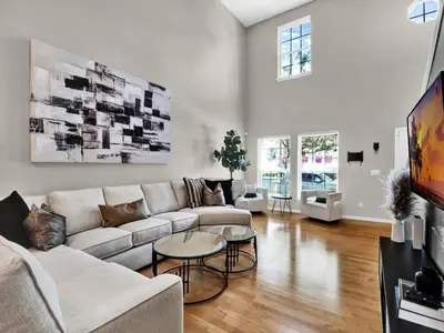 a living room with a couch and a table at Beautiful townhouse centrally located in Orlando