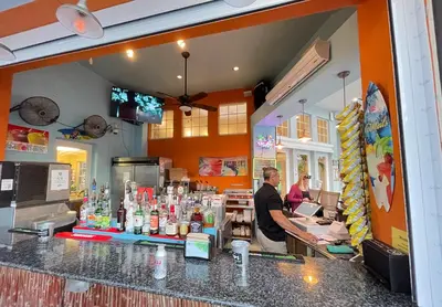 two people standing at a counter in a restaurant at Windsor Palms, next to clubhouse in Kissimmee
