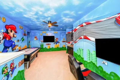 a bedroom with a mario game room with a table at EPIC 10min Disney Fun Villa, Mini Golf, Arcade, Theater in Orlando