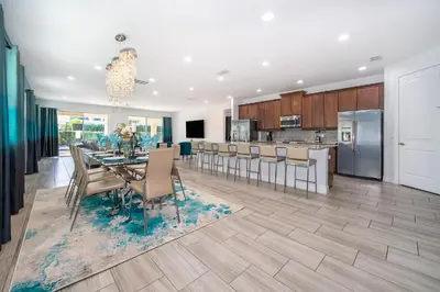 a dining room and kitchen with a table and chairs at EPIC Disney 10Min Retreat, 8BR Resort Villa and Arcade in Orlando