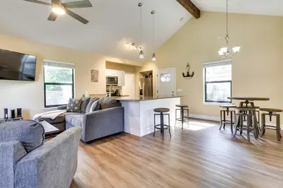 a living room with two couches and a kitchen at St Cloud Vacation Rental - Walk to Lakefront Park! in Saint Cloud