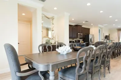 a dining room with a wooden table and chairs at 411-IBRHAIM · 411 Sparkling Spotless Villa in Encore in Orlando
